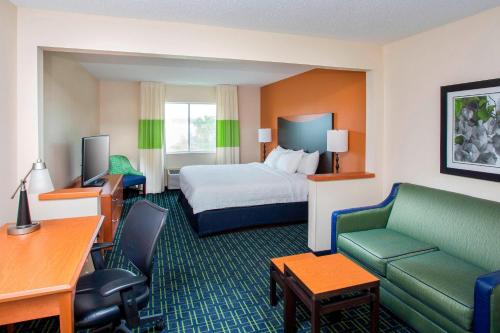 a hotel room with a bed and a couch at Fairfield Inn Middletown Monroe in Middletown