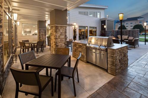 a patio with a grill and tables and chairs at Residence Inn by Marriott East Peoria in Peoria