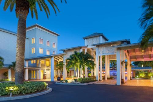 a large building with palm trees in front of it at Marriott Hutchinson Island Beach Resort, Golf & Marina in Stuart
