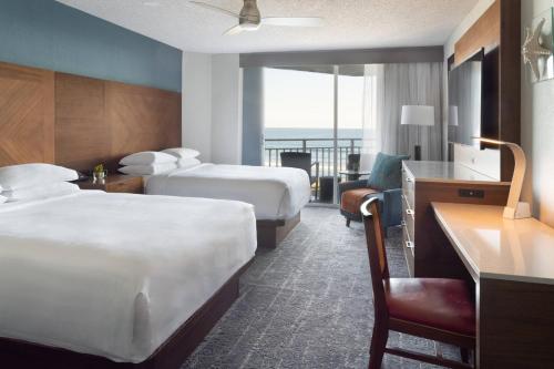 a hotel room with two beds and a balcony at Marriott Hutchinson Island Beach Resort, Golf & Marina in Stuart