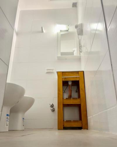 a bathroom with a sink and a mirror at Hotel Alcazar in Buenos Aires