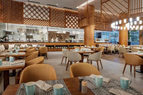 a restaurant with tables and chairs and a bar at Rabat Marriott Hotel in Rabat