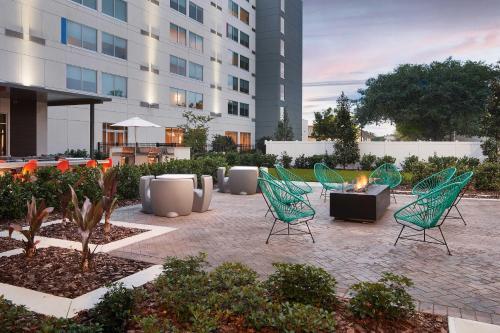 a patio with chairs and a fire pit in front of a building at Element by Westin Orlando International Drive in Orlando