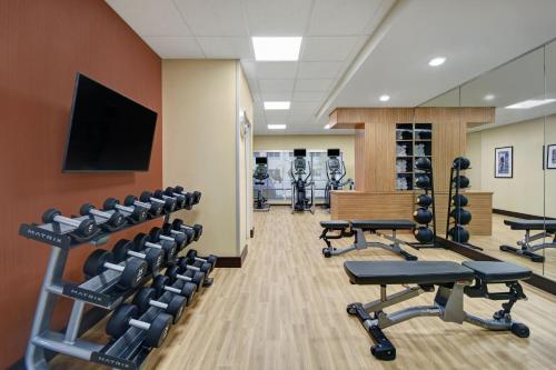 a gym with rows of chairs and a flat screen tv at TownePlace Suites by Marriott Grand Rapids Wyoming in Wyoming