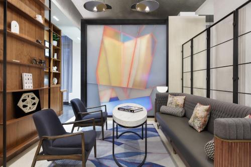a living room with a couch and chairs and a table at Le Meridien New York, Fifth Avenue in New York