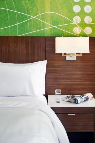 a bedroom with a bed and a table with a glass at Renaissance Nashville Hotel in Nashville