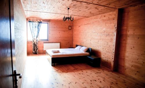 a bedroom with a bed in a wooden room at Villa SeaZone in Zatoka