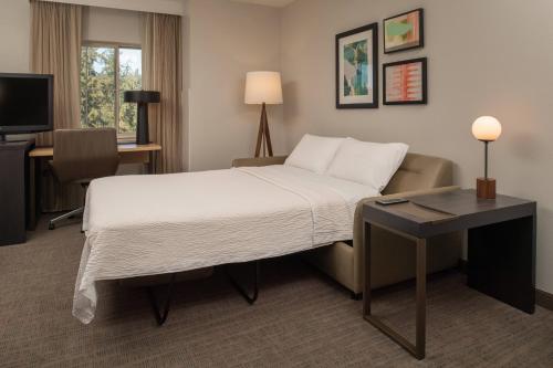 a hotel room with a bed and a desk at Residence Inn Seattle East/Redmond in Redmond