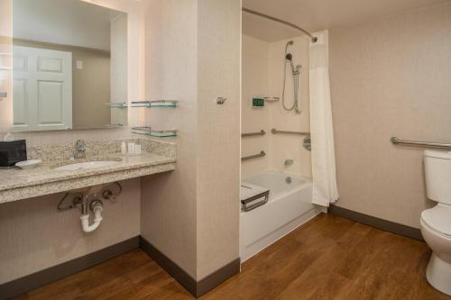 a bathroom with a sink and a toilet and a tub at Residence Inn Seattle East/Redmond in Redmond