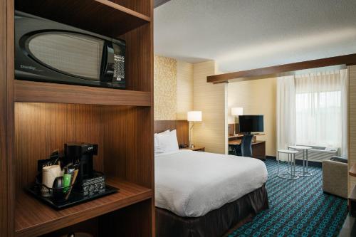 a hotel room with a bed and a television at Fairfield Inn & Suites by Marriott Tacoma DuPont in DuPont