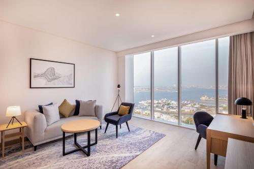 a living room with a couch and a table at Four Points by Sheraton Jeddah Corniche in Jeddah