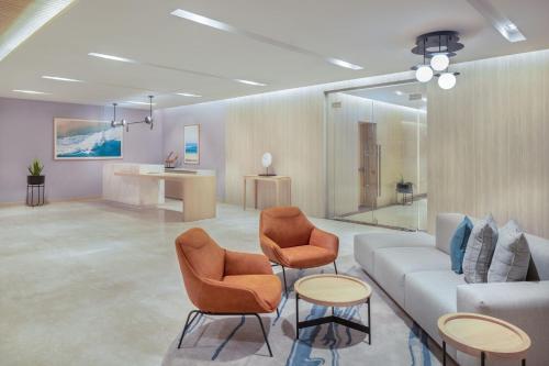 a living room with a couch and two chairs at Four Points by Sheraton Jeddah Corniche in Jeddah