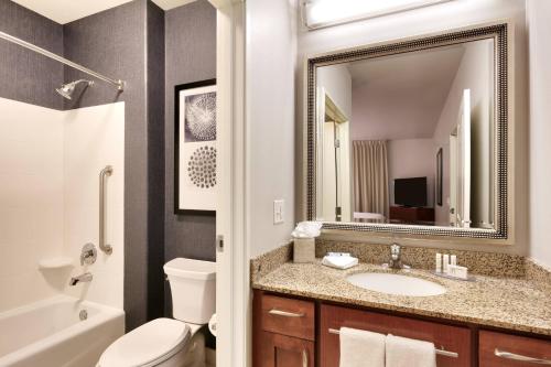 a bathroom with a sink and a toilet and a mirror at Residence Inn by Marriott Idaho Falls in Idaho Falls