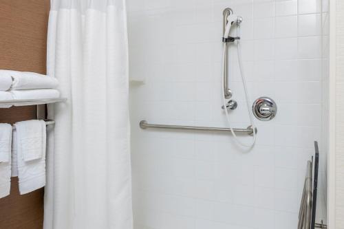 a shower with a white shower curtain in a bathroom at Fairfield Inn & Suites Lubbock in Lubbock