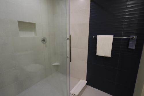a bathroom with a shower with a glass door at Fairfield Inn & Suites by Marriott Mexicali in Mexicali