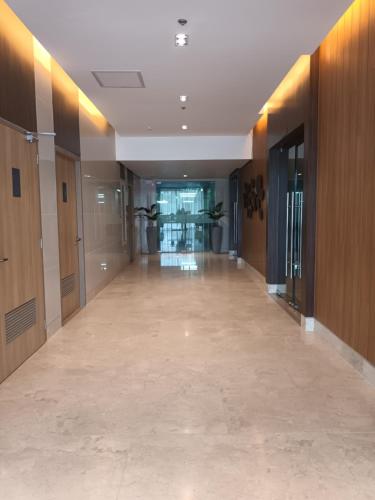 an empty hallway in a building with wooden walls and floors at Condo Shore 3 Residences MOA complex , near NAIA and Casinos in Manila