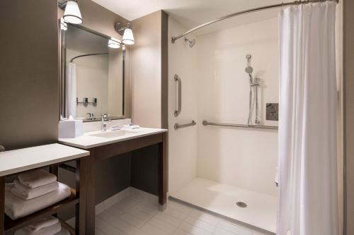 a bathroom with a sink and a shower at Four Points by Sheraton at Phoenix Mesa Gateway Airport in Mesa