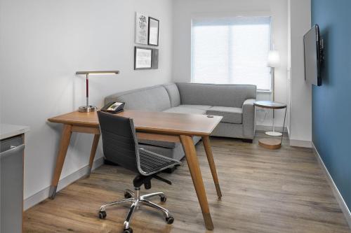 a living room with a table and a couch at Element Edmonton West in Edmonton