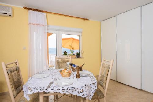 a dining room with a table and a window at Panoramare Komplex Vesna in Zagorje