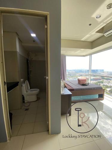 a bathroom with a bed and a toilet in a room at 180 degree view of manila bay in Manila