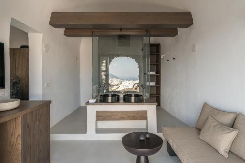 a kitchen with a counter with two pots on it at Honeymoon Petra Villas in Imerovigli