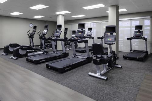a gym with a lot of treadmills and elliptical machines at Residence Inn by Marriott St. Louis West County in Saint Louis