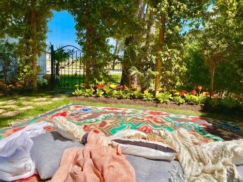 a blanket laying on the ground in a park at Beach Garden Paradise in Durrës