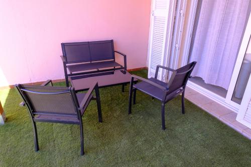 two chairs and a table and a table and two chairs at Casa del sol 2 bedrooms in Morro del Jable
