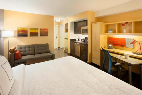 a hotel room with a bed and a couch at TownePlace Suites by Marriott Toronto Northeast/Markham in Markham