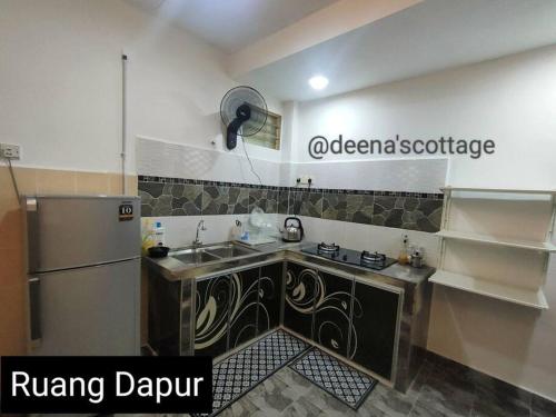a kitchen with a sink and a refrigerator at Deena's Cottage Kulim Hitech Hospital Kulim, Three-bedrooms Single Storey Terrace House in Kulim