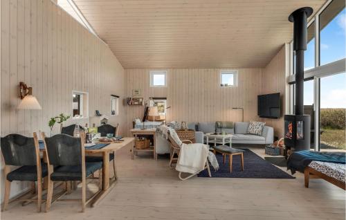 a living room with a couch and a table at Beautiful Home In Store Fuglede in Store Fuglede