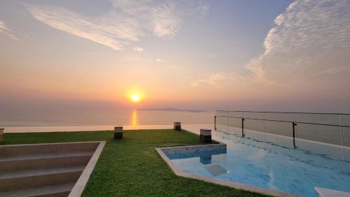 a view of the sunset from a house with a swimming pool at the andromeda condominium seaview in Pattaya South