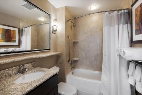 a bathroom with a sink and a tub and a toilet at TownePlace Suites by Marriott Seguin in Seguin