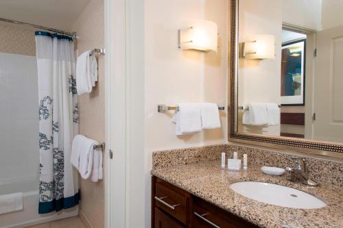 a bathroom with a sink and a mirror at Residence Inn Toledo Maumee in Maumee