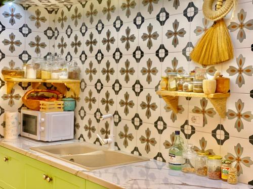a kitchen with a counter top with a microwave at Beach Garden Paradise in Durrës
