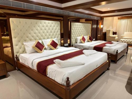 a bedroom with two beds in a room at Holiday Valley Hotels And Resorts in Denkanikottai