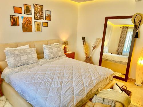 a bedroom with a large bed and a mirror at Beach Garden Paradise in Durrës