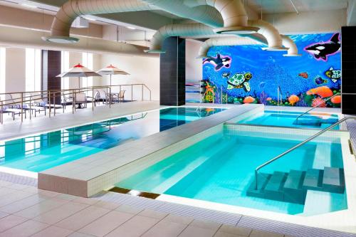 a large swimming pool with a mural of an aquarium at Le Westin Montreal in Montreal