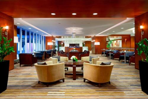a lobby with chairs and a table in a hotel at Le Westin Montreal in Montréal