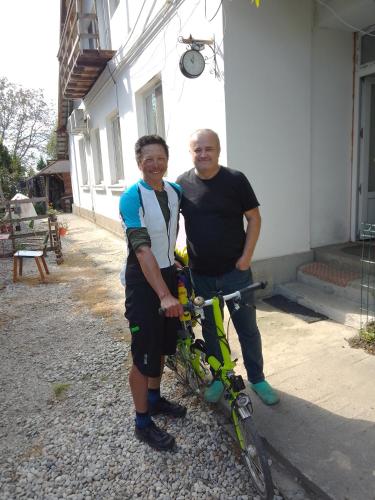 a man standing next to a man holding a bike at Casa Mocanu in Giurgiu