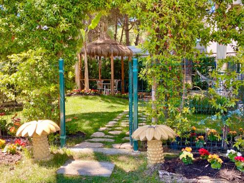 a garden with a gazebo and a garden with mushrooms at Beach Garden Paradise in Durrës