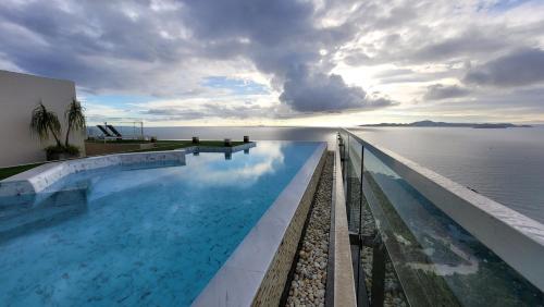 a swimming pool with a view of the water at Andromeda Condo By Feng in Pattaya South