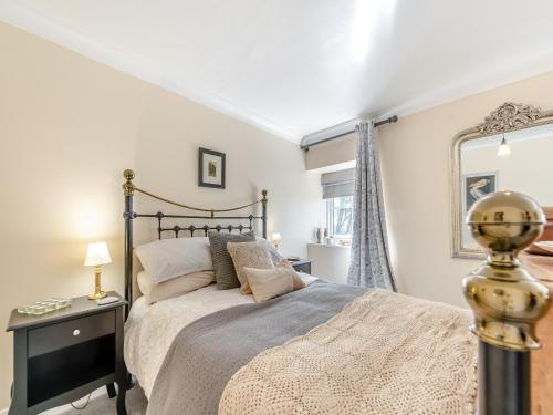 a bedroom with a large bed and a mirror at The Stable in Roch