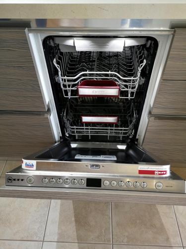 an oven with the front door open in a room at Elioj house in Leptokaria