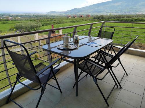 a table and two chairs on a balcony at Elioj house in Leptokaria
