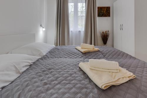 a bedroom with a bed with two towels on it at Villa Stjepanovic in Tribanj-Krušćica
