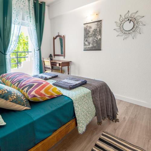 a bedroom with a bed and a window at City Dacha - Ocean in Albufeira