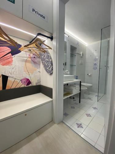 a bathroom with a sink and a counter with a mirror at DUOMO26 BOUTIQUE APARTMENT in Desenzano del Garda
