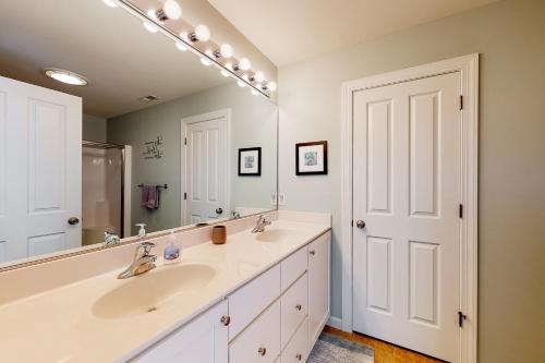 a bathroom with two sinks and a large mirror at Bayville Shores - 35735 Coleman Ave in Selbyville