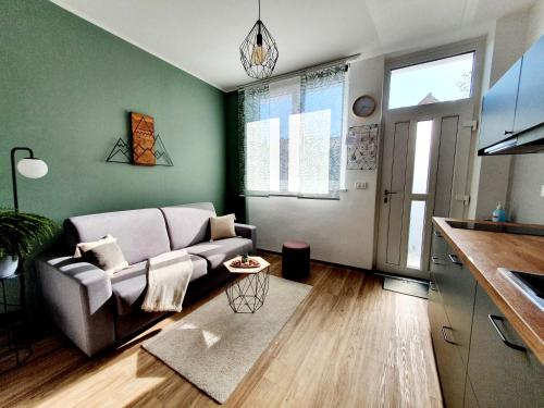 a living room with a couch and a kitchen at Harmony apartments in Portorož